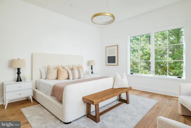 a bedroom with a bed and a large window