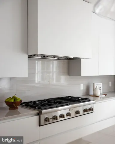 a stove top oven sitting inside of a kitchen