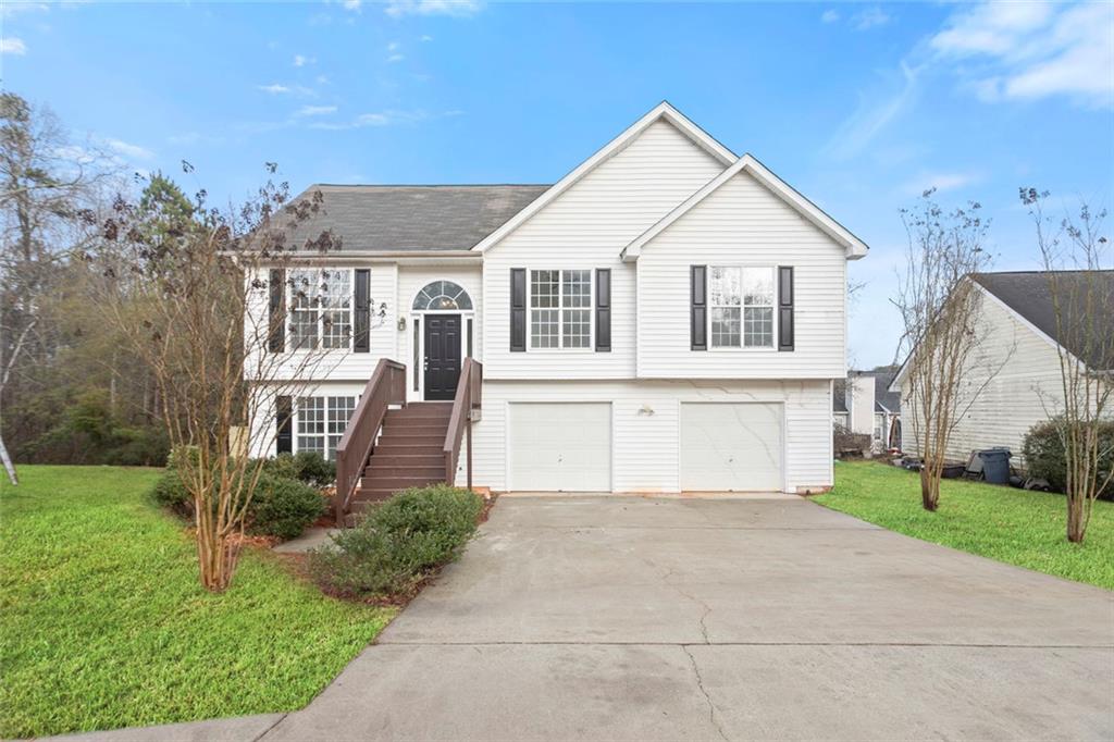 a front view of a house with a yard and garage
