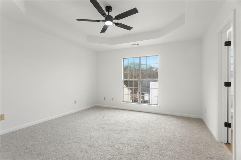 6608 Chesepeake Trail Rex, GA 30273 - Photo 11 of 32 an empty room with windows and fan