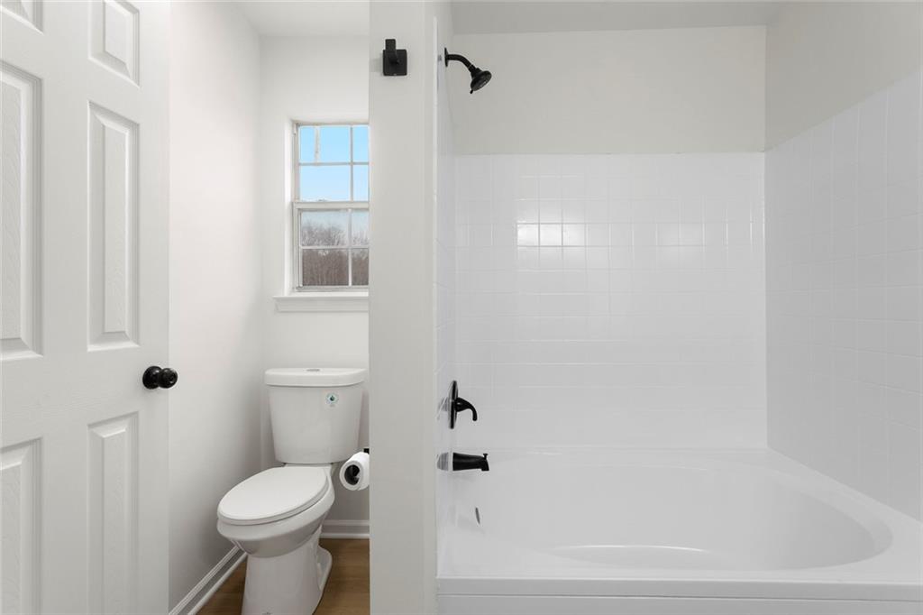 6608 Chesepeake Trail Rex, GA 30273 - Photo 14 of 32 a white toilet sitting next to a bathroom sink