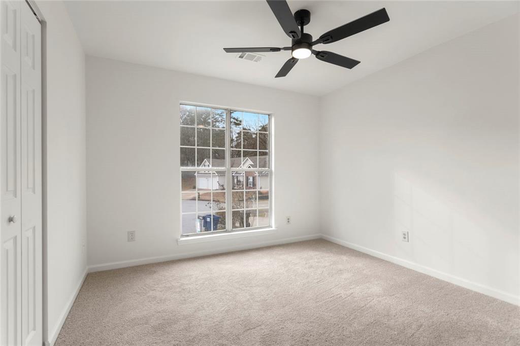 6608 Chesepeake Trail Rex, GA 30273 - Photo 16 of 32 an empty room with windows and ceiling fan