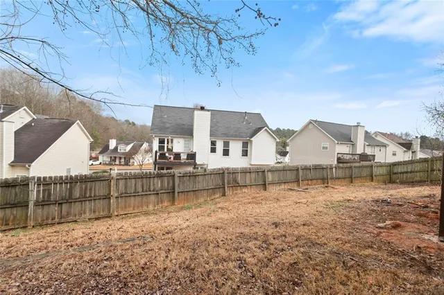 a view of a house with a backyard