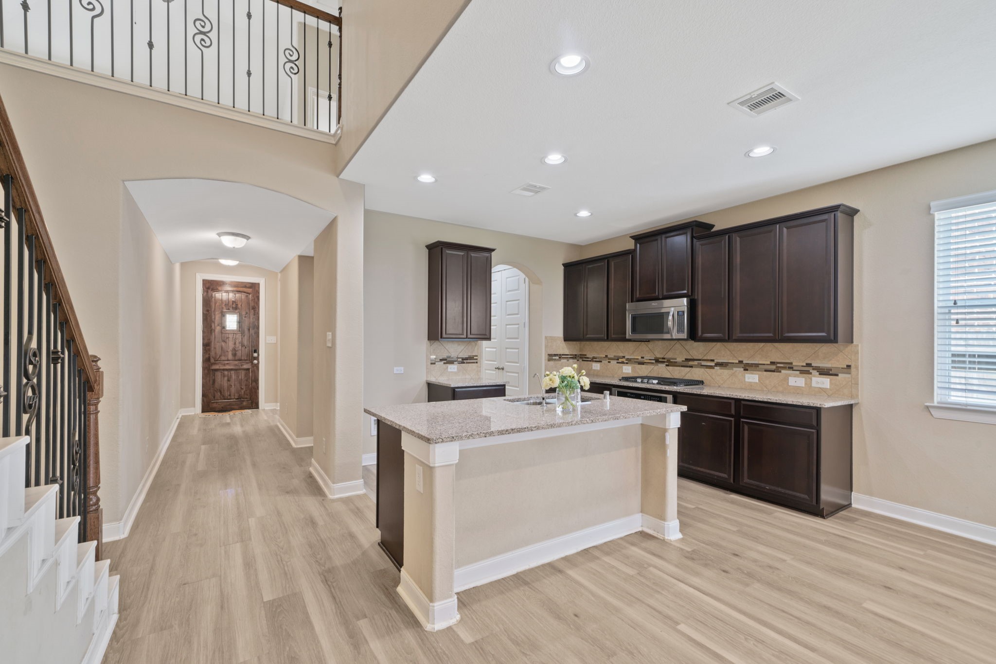 22523 Birch Ridge Meadow Drive Spring, TX 77389 - Photo 6 of 39 a kitchen with stainless steel appliances kitchen island granite countertop a stove and a sink