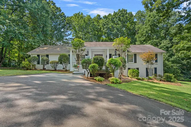 a front view of a house with yard and green space