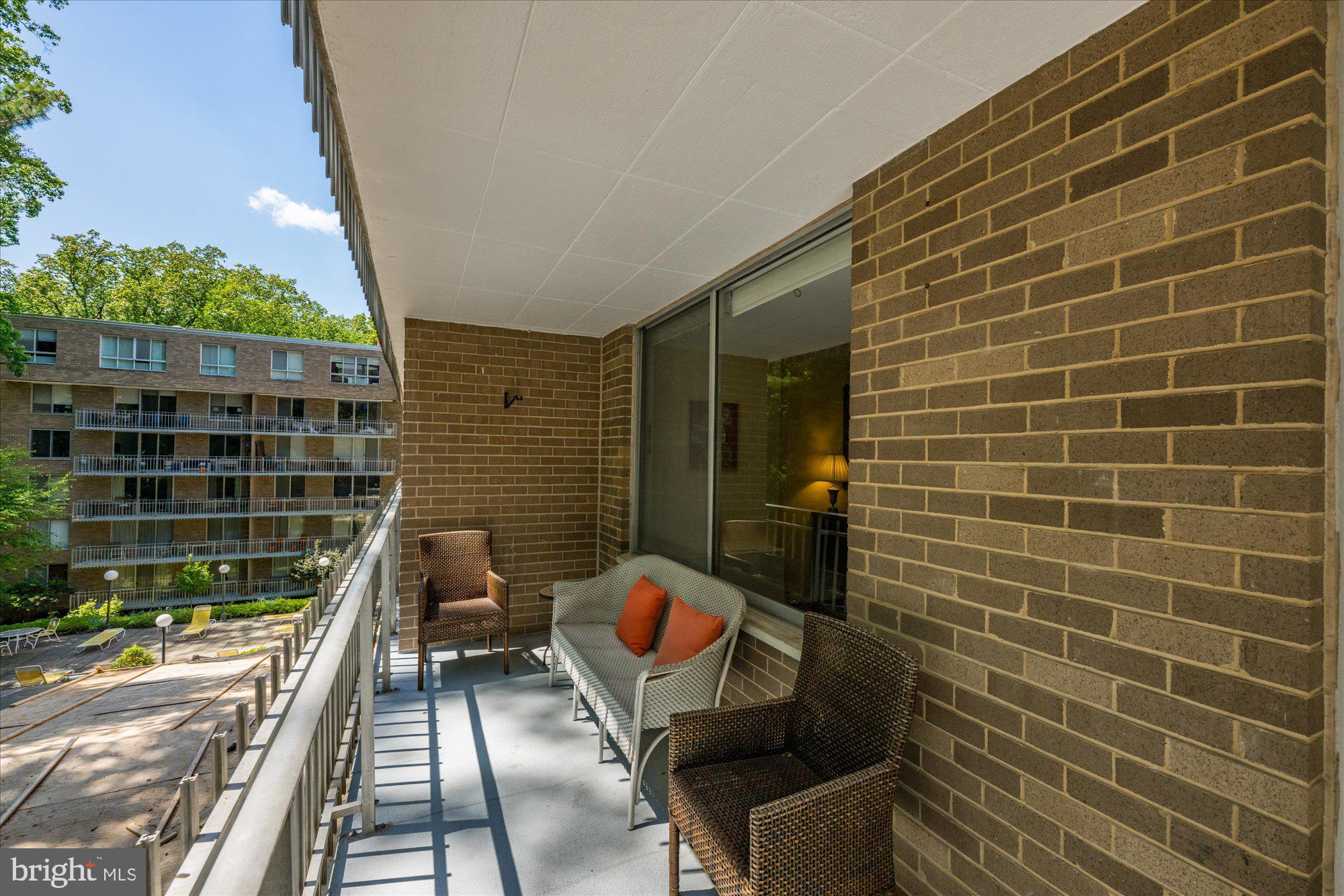 4100 Cathedral Avenue Northwest, Unit 717 Washington, DC 20016 - Photo 12 of 34 a view of balcony with wooden floor and outdoor seating