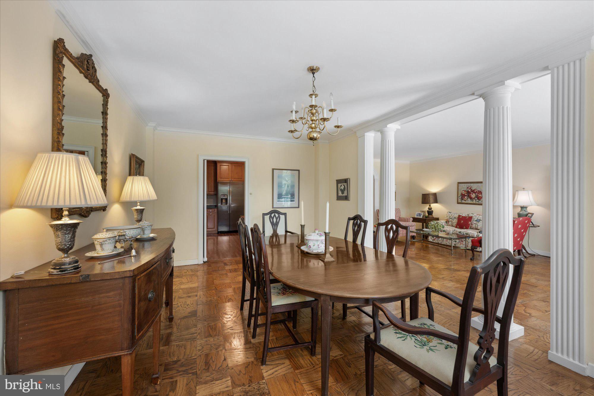 4100 Cathedral Avenue Northwest, Unit 717 Washington, DC 20016 - Photo 15 of 34 a dining room with furniture and chandelier