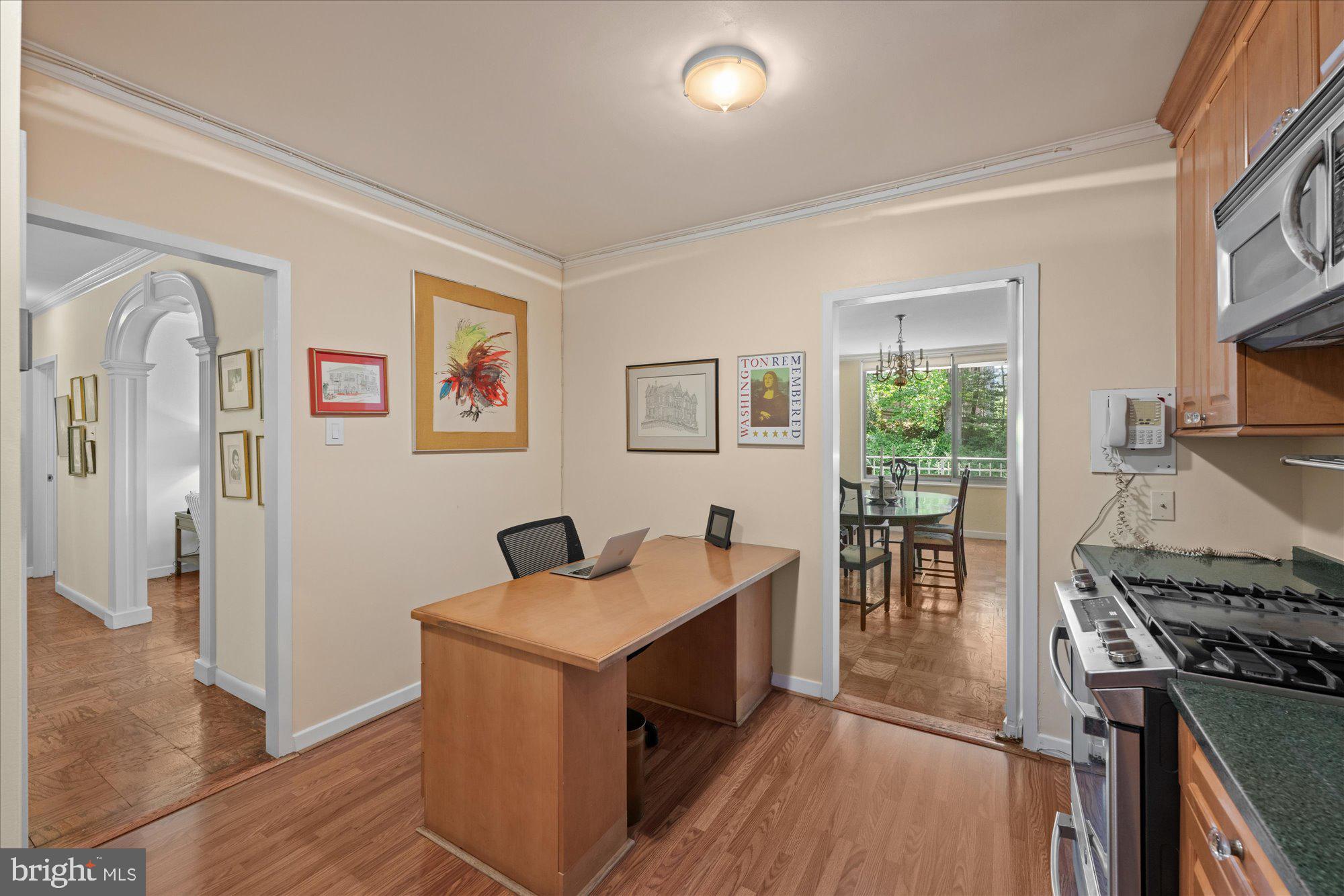 4100 Cathedral Avenue Northwest, Unit 717 Washington, DC 20016 - Photo 19 of 34 a view of a workspace with furniture and a kitchen