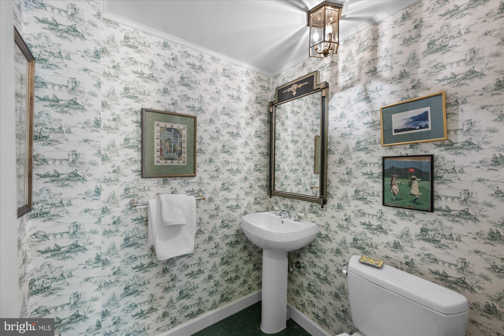 4100 Cathedral Avenue Northwest, Unit 717 Washington, DC 20016 - Photo 21 of 34 a bathroom with a toilet sink and mirror
