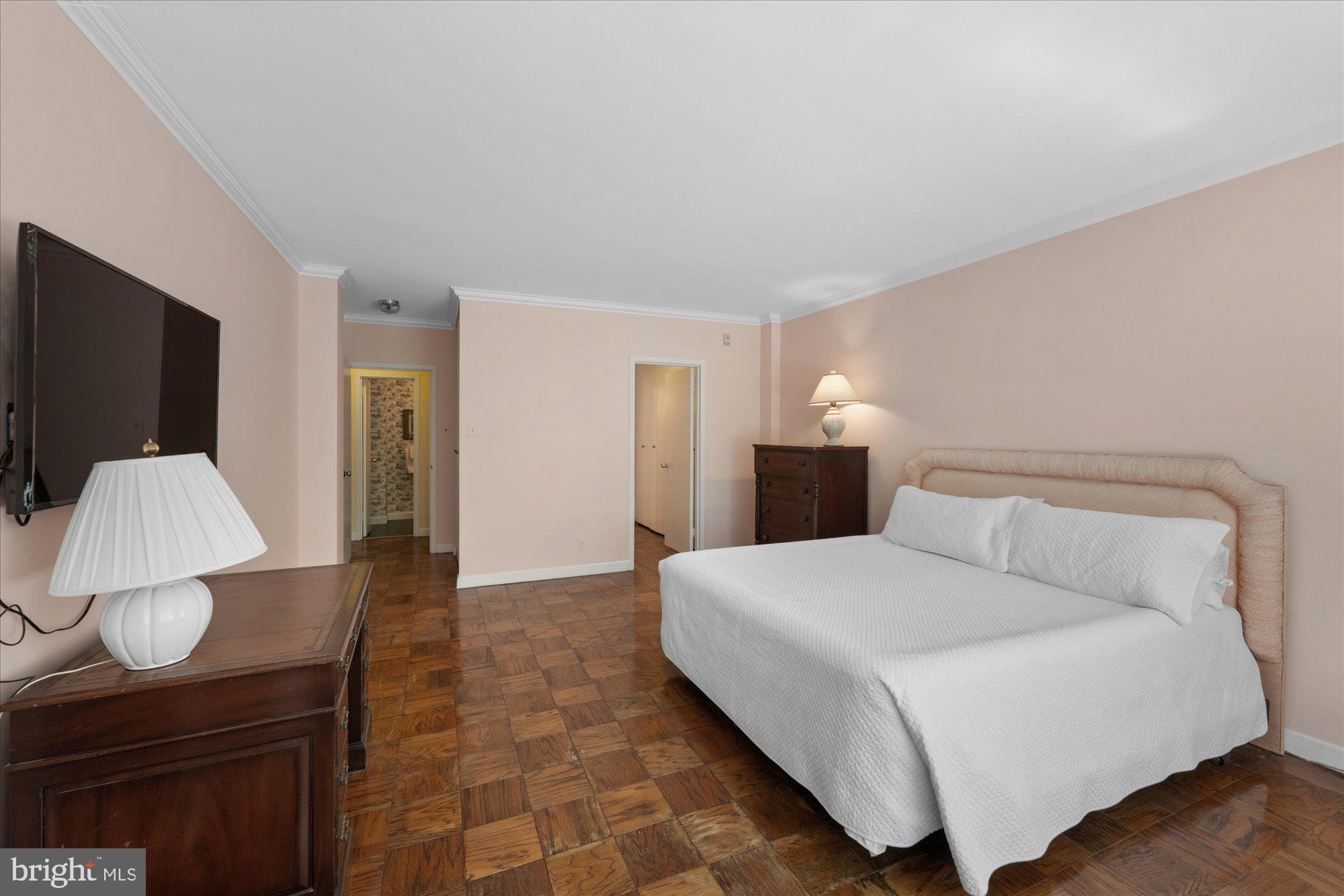 4100 Cathedral Avenue Northwest, Unit 717 Washington, DC 20016 - Photo 24 of 34 a bedroom with a bed and a television
