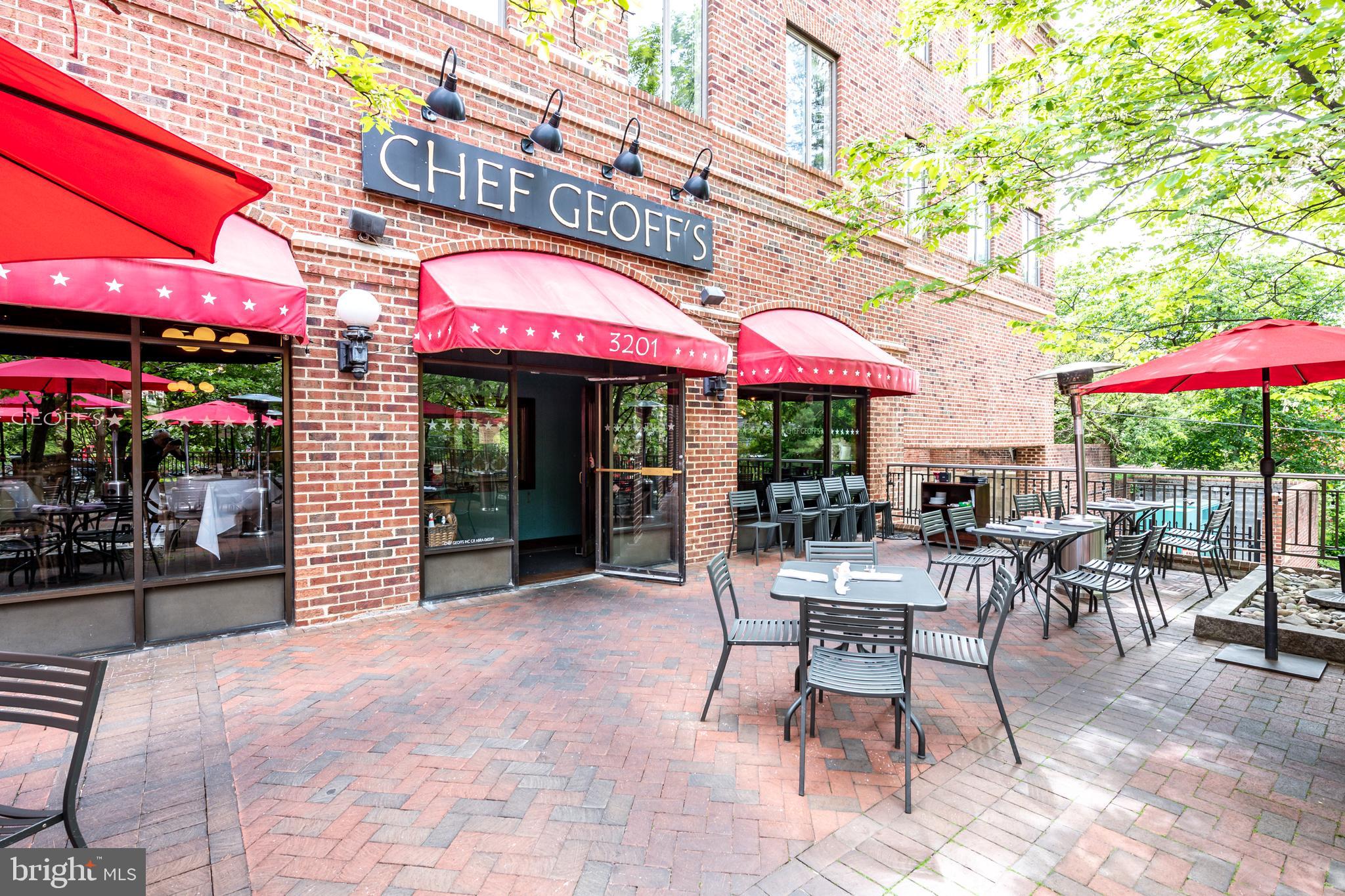 4100 Cathedral Avenue Northwest, Unit 717 Washington, DC 20016 - Photo 34 of 34 a view of a cafe with a table and chairs under an umbrella