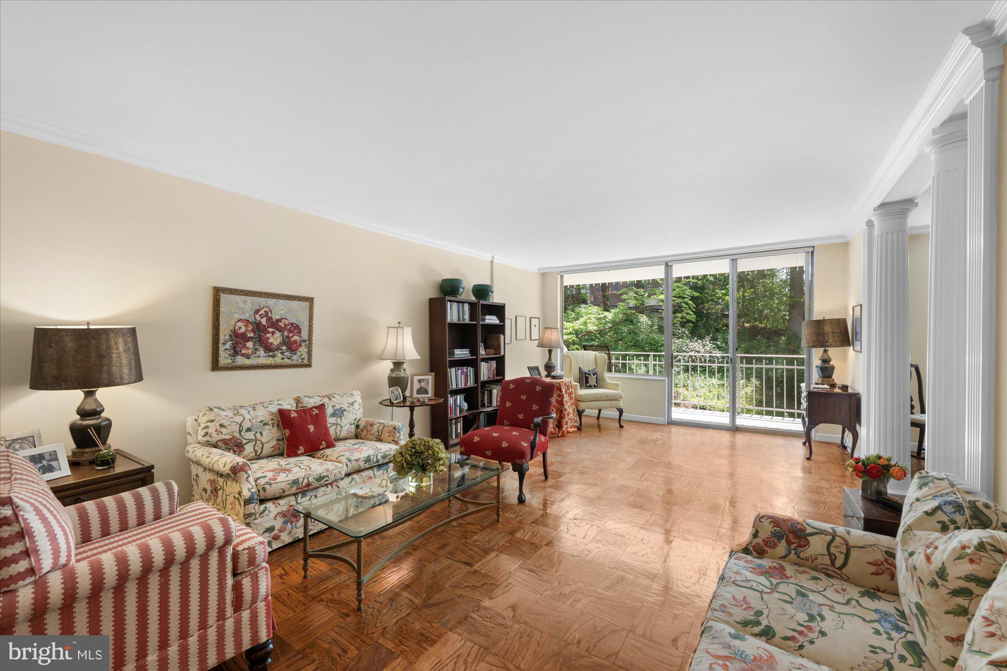 4100 Cathedral Avenue Northwest, Unit 717 Washington, DC 20016 - Photo 8 of 34 a living room with furniture and a large window with balcony view