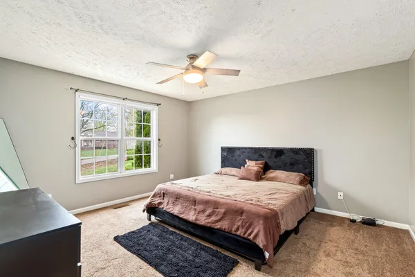 a bedroom with a large bed and a window