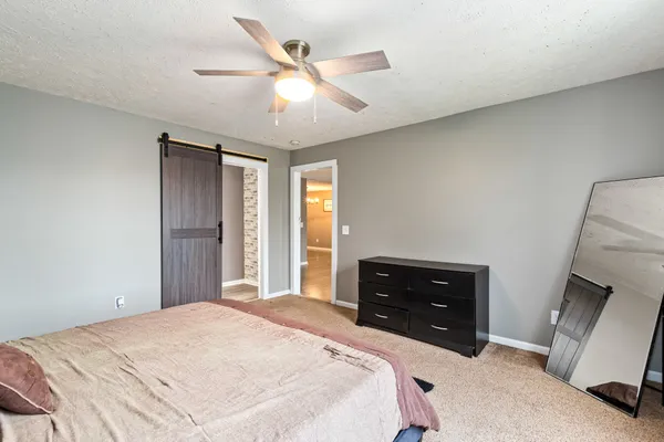 a bedroom with a bed and a dresser