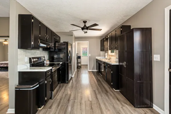 a kitchen with stainless steel appliances a sink stove and refrigerator