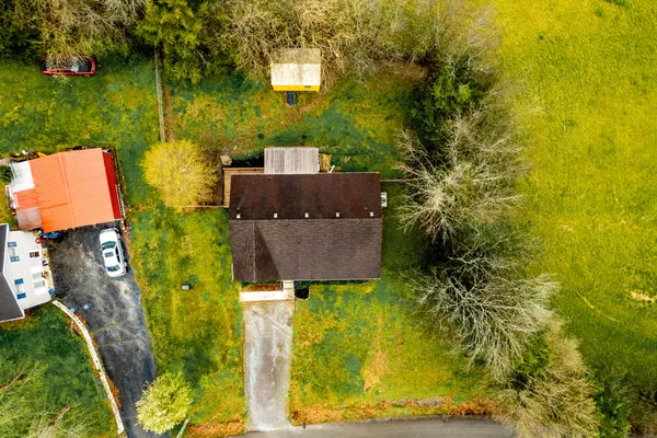 aerial view of a house with a yard