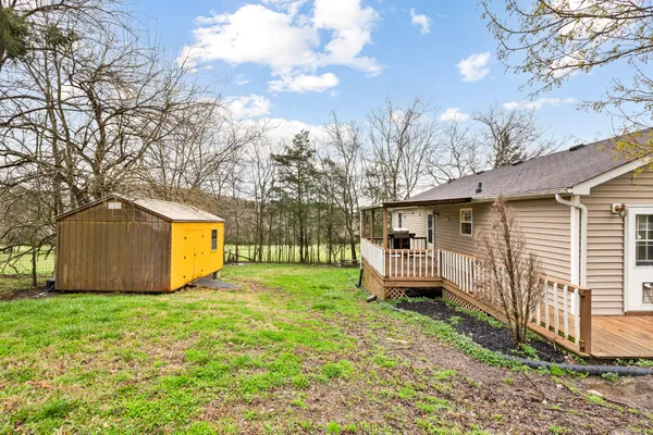 a view of a house with backyard and garden