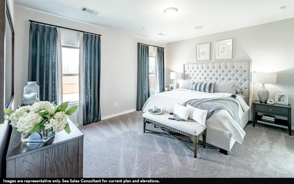 a bedroom with a bed table and a couch
