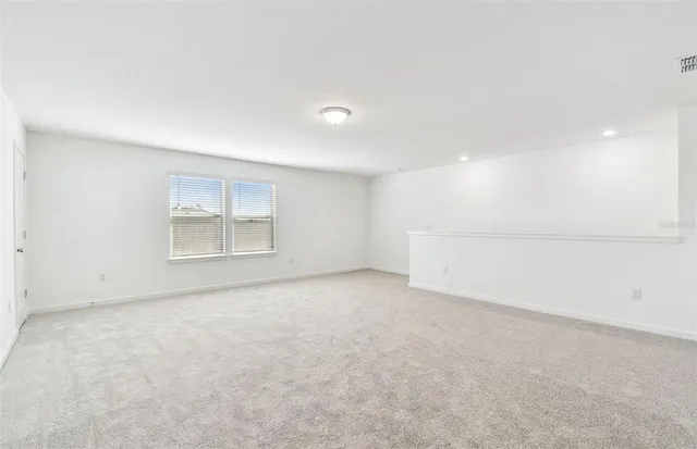 an empty room with a empty space and windows