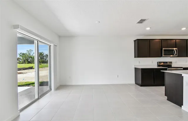 a view of kitchen with microwave oven and cabinets