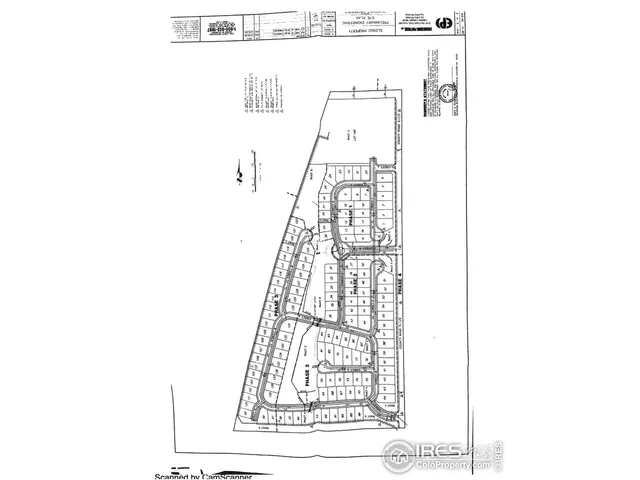 a view of a living room with a white wall and a large window