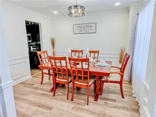 a dining room with furniture and wooden floor