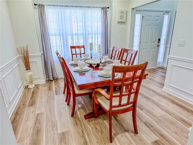 a view of a dining room with furniture and wooden floor