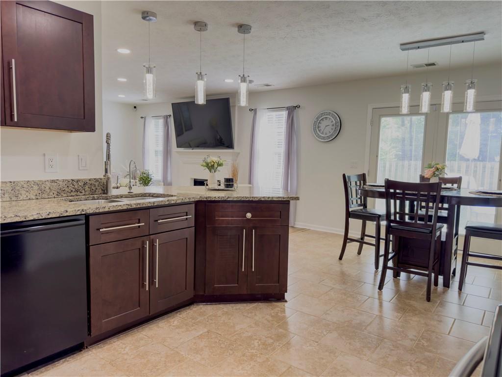 1559 Woodmore Road Southwest Marietta, GA 30008 - Photo 15 of 43 a kitchen with granite countertop a sink and a refrigerator