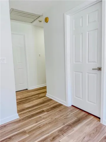 a view of a room with wooden floor and cabinet