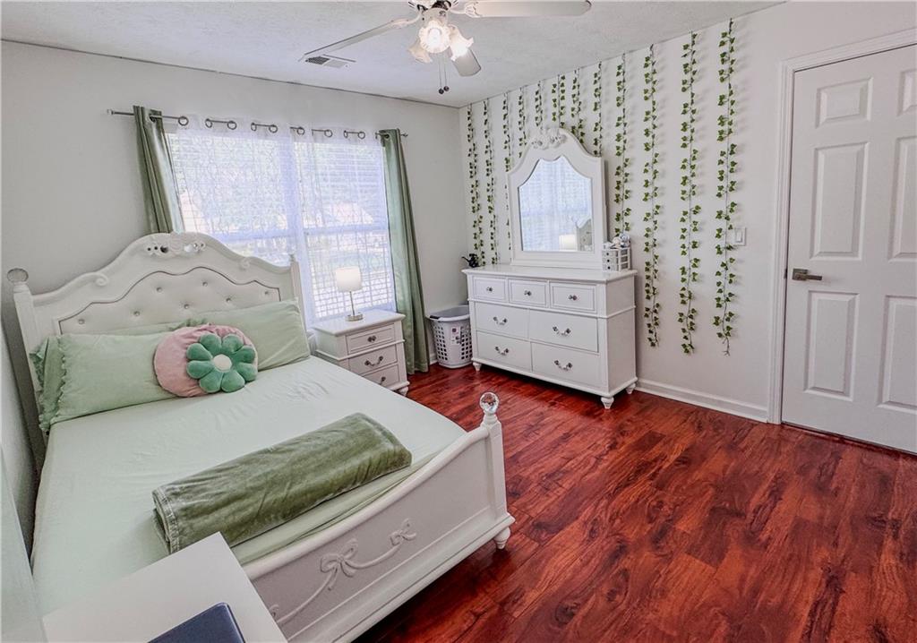 1559 Woodmore Road Southwest Marietta, GA 30008 - Photo 29 of 43 a bedroom with a bed and a dresser