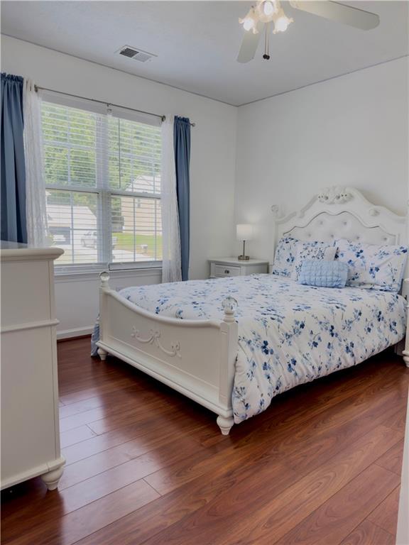 1559 Woodmore Road Southwest Marietta, GA 30008 - Photo 36 of 43 a bedroom with a bed and wooden floor