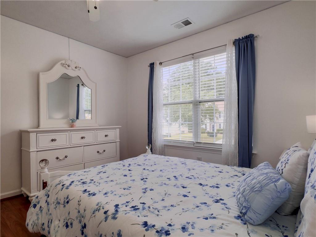 1559 Woodmore Road Southwest Marietta, GA 30008 - Photo 37 of 43 a bedroom with a bed and a dresser