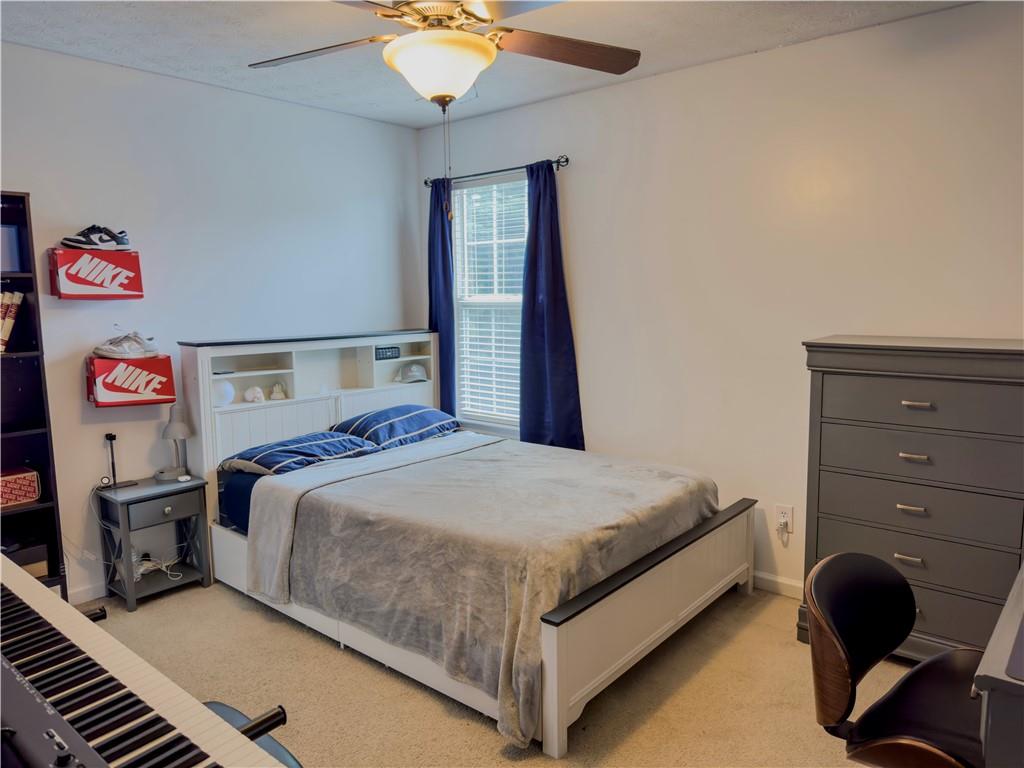 1559 Woodmore Road Southwest Marietta, GA 30008 - Photo 40 of 43 a bedroom with a bed and a chandelier