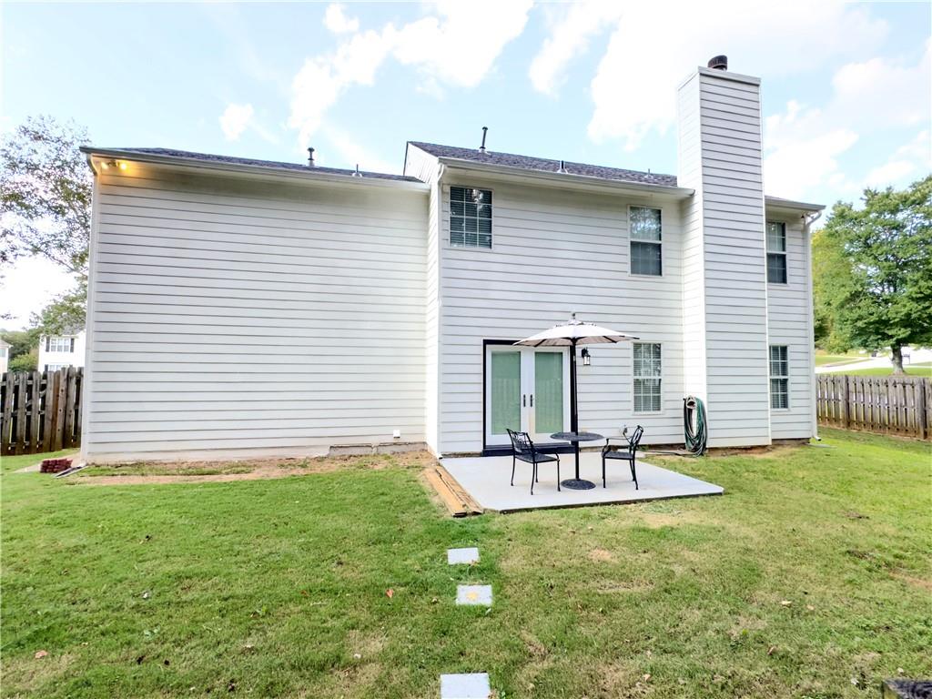 1559 Woodmore Road Southwest Marietta, GA 30008 - Photo 5 of 43 a house view with outdoor seating space and garden