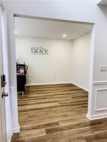 a view of empty room with wooden floor