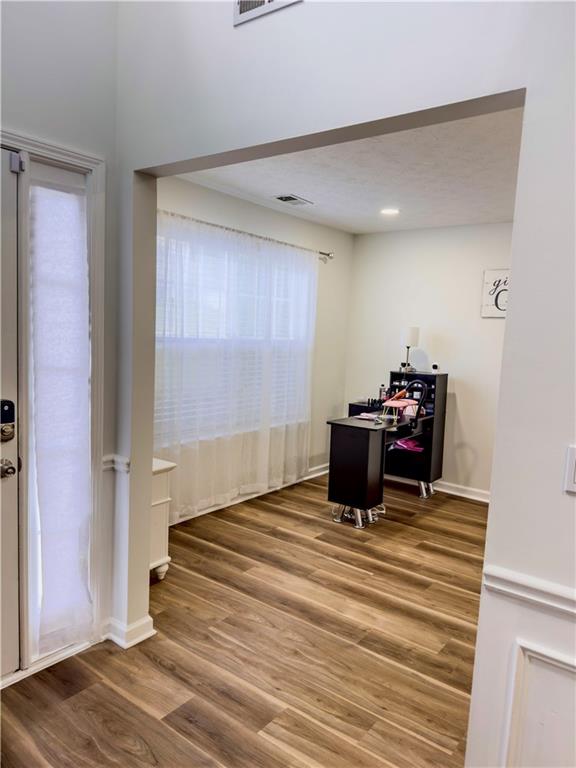 1559 Woodmore Road Southwest Marietta, GA 30008 - Photo 10 of 43 a bedroom with a bed and wooden floor