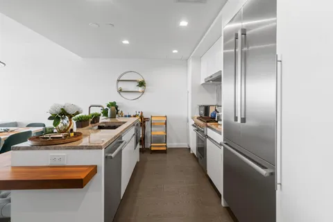 a open kitchen with a sink a stove and chairs