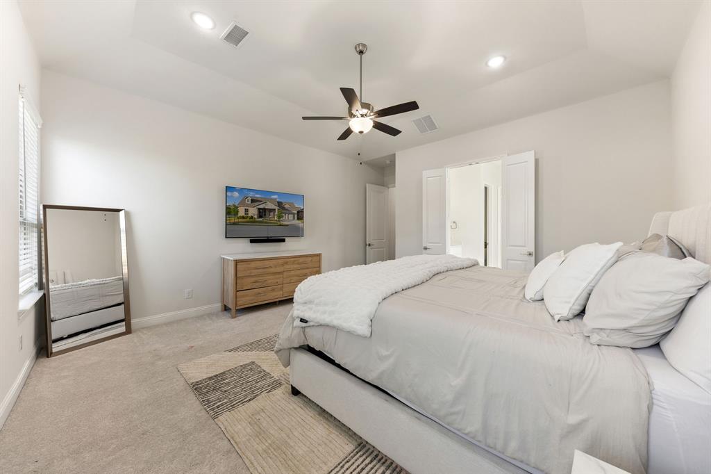 8808 Royal Star Road Rowlett, TX 75089 - Photo 23 of 40 a bedroom with a bed chandelier and a window