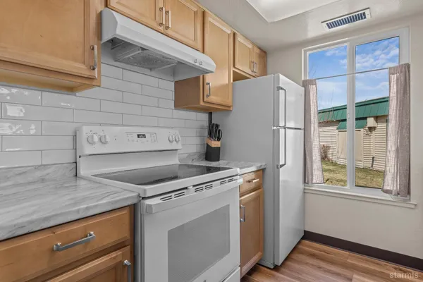 a kitchen with a stove and a refrigerator