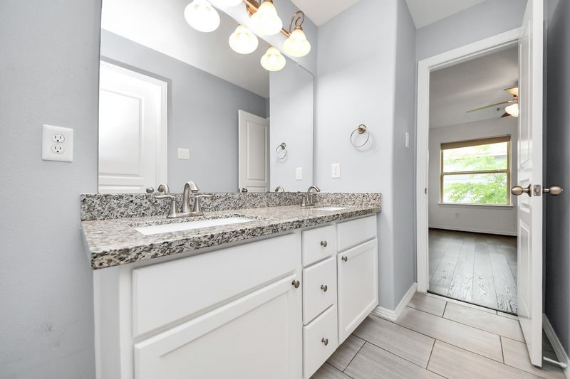 4222 Drake Street Houston, TX 77005 - Photo 21 of 28 a bathroom with a granite countertop sink and a mirror
