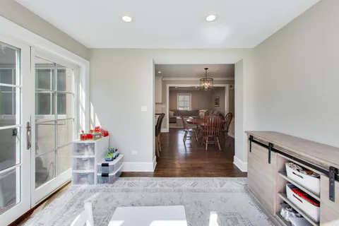 a living room with furniture and a dining table