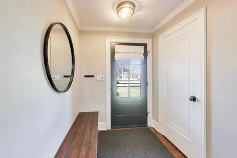 a view of an entryway with wooden floor