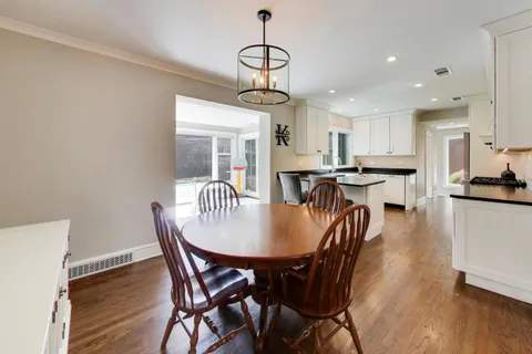 a dining room with furniture and wooden floor