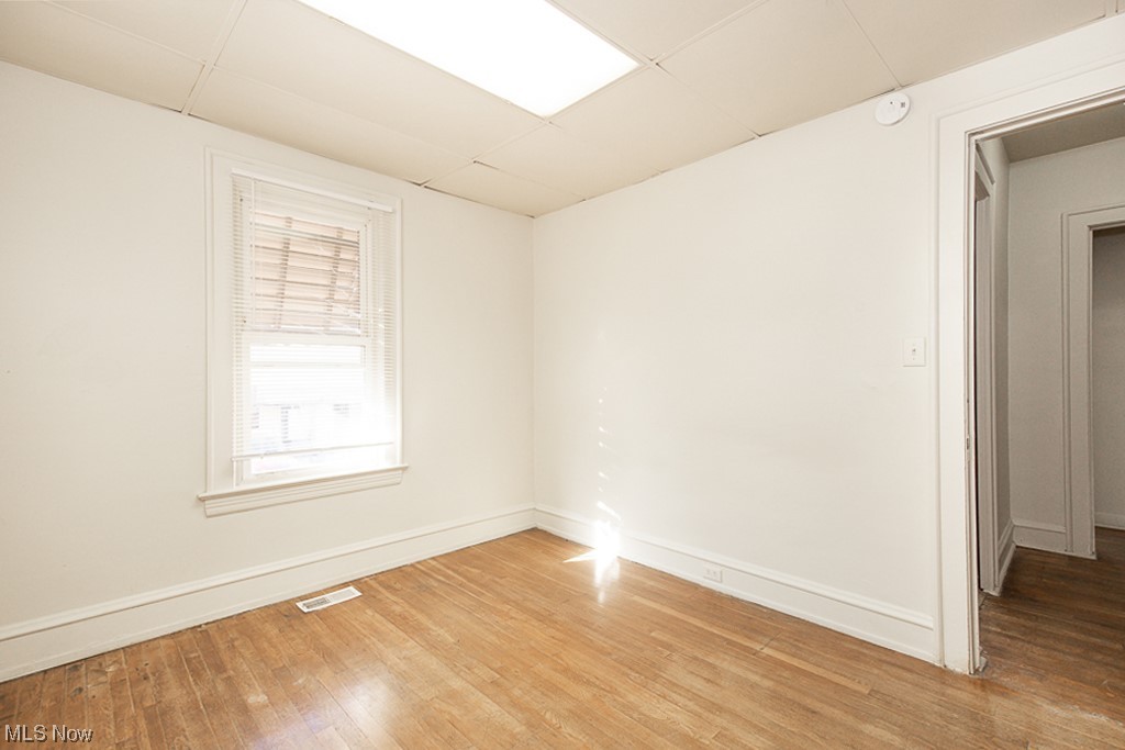 4574 Broadview Road Cleveland, OH 44109 - Photo 17 of 30 Unfurnished room with a drop ceiling and light hardwood / wood-style floors