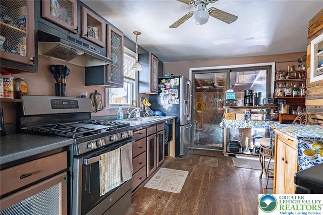 a kitchen with stainless steel appliances granite countertop a stove and a refrigerator