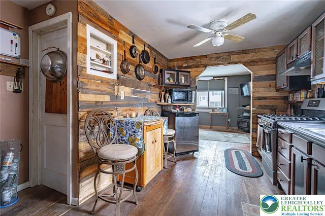 a kitchen with stainless steel appliances granite countertop a stove refrigerator and cabinets