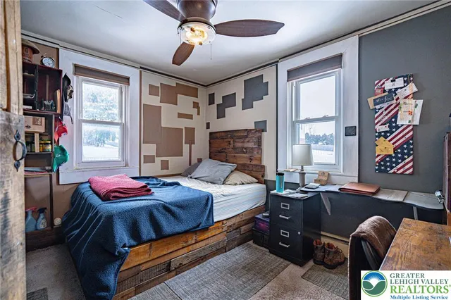 a bedroom with a bed and a window