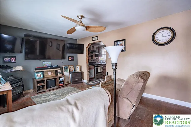 a view of a livingroom with furniture and a fan