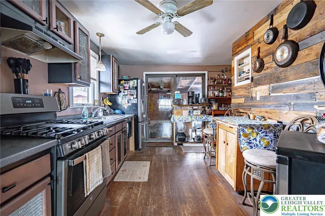 a kitchen with stainless steel appliances granite countertop a stove and cabinets