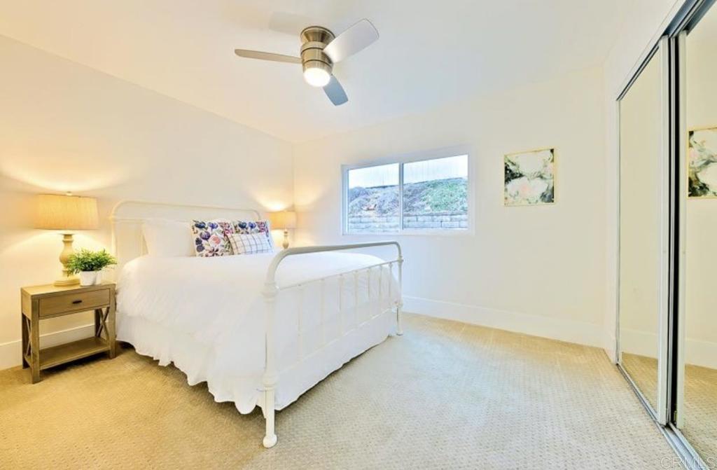 436 Alviso Way Encinitas, CA 92024 - Photo 14 of 18 a white bed sitting in a room next to a window